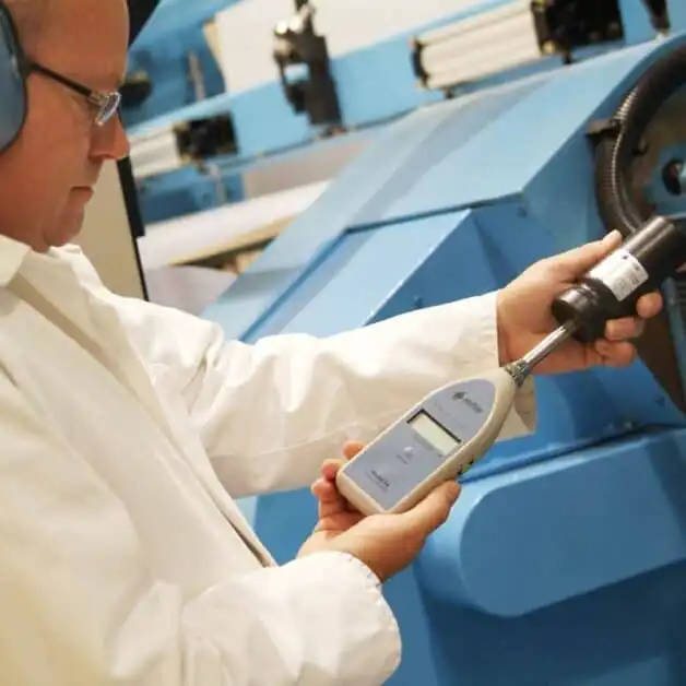 Engineer calibrating a MODEL 14 Digital Noise Meter before a noise measurement