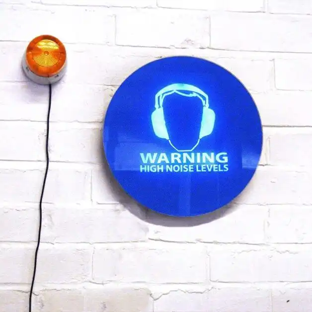The SafeEar Noise-activated Warning Sign mounted on wall for workplace noise monitoring